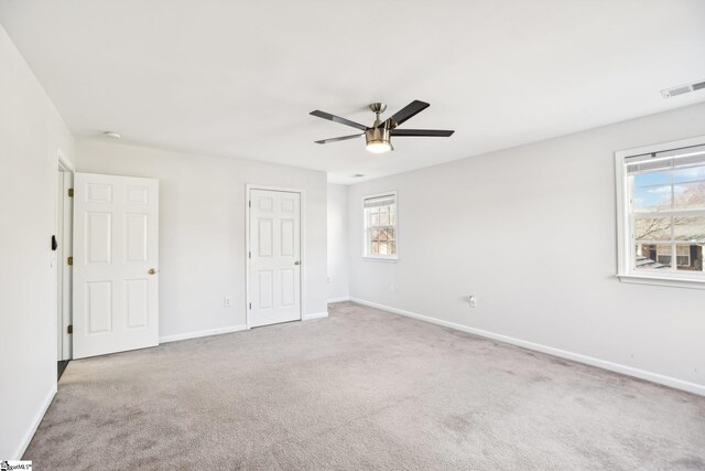 carpeted empty room featuring ceiling fan