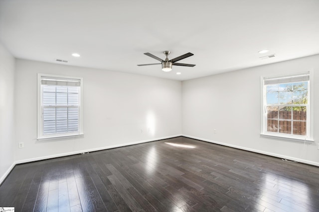 empty room with ceiling fan and dark wood-type flooring