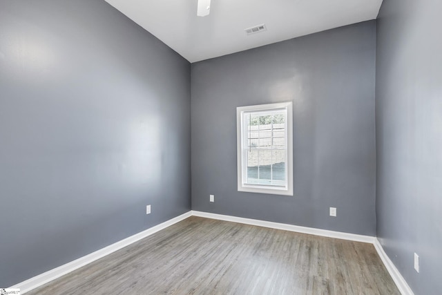 empty room with ceiling fan and light wood-type flooring