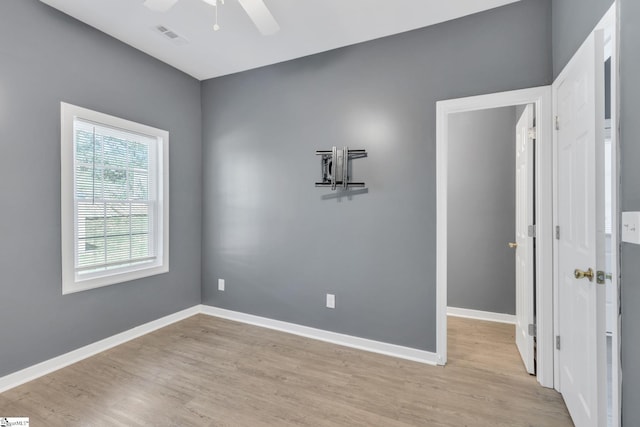 unfurnished room featuring light wood-type flooring and ceiling fan