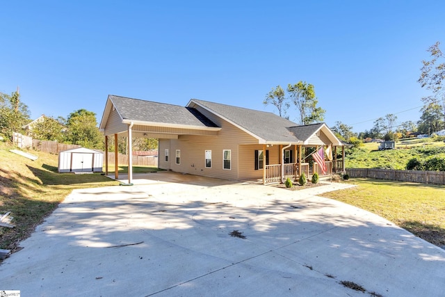 view of front of property with covered porch, a shed, and a front lawn