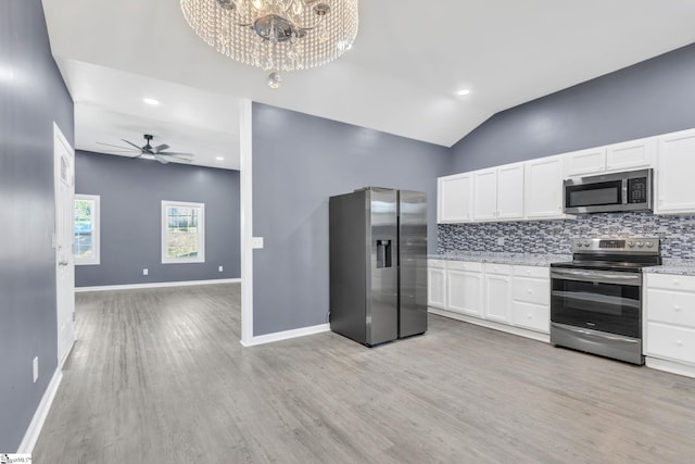 kitchen featuring decorative backsplash, white cabinets, stainless steel appliances, and light hardwood / wood-style floors