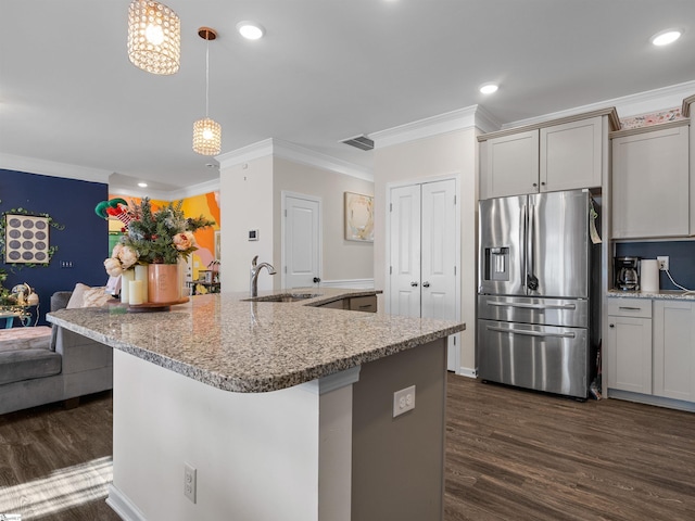 kitchen featuring decorative light fixtures, dark hardwood / wood-style flooring, stainless steel fridge with ice dispenser, and sink