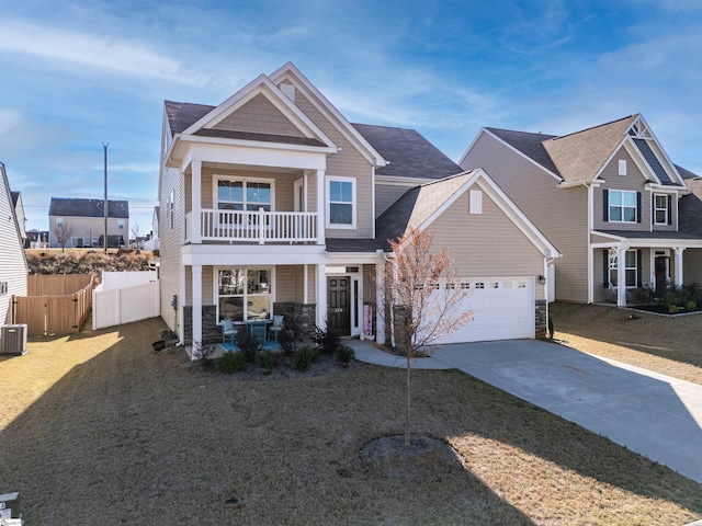 craftsman-style house featuring central AC unit, a garage, a balcony, and a front lawn