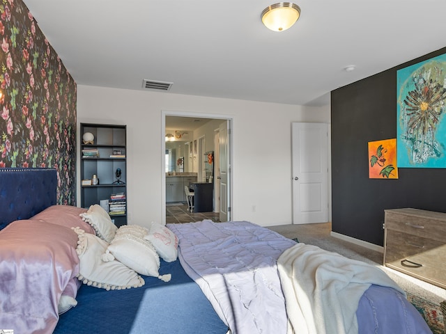 bedroom featuring carpet and ensuite bath