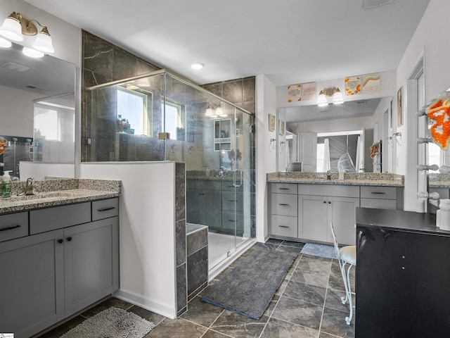 bathroom featuring vanity and a shower with door