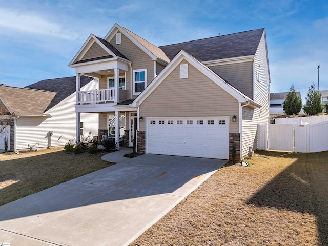 view of front of house with a balcony, a front yard, and a garage