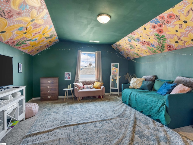 carpeted bedroom with lofted ceiling