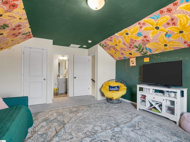 interior space featuring carpet flooring, ensuite bath, and lofted ceiling