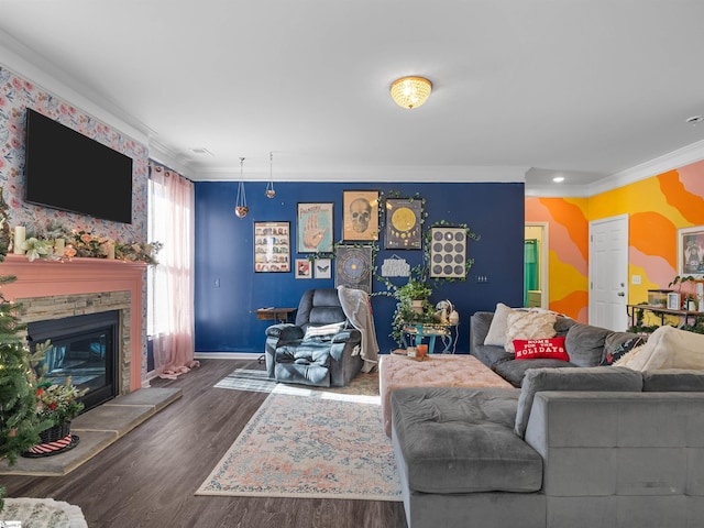 living room with ornamental molding, a stone fireplace, and dark wood-type flooring