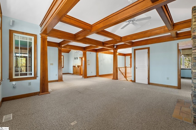 interior space featuring light carpet, ornate columns, and beamed ceiling