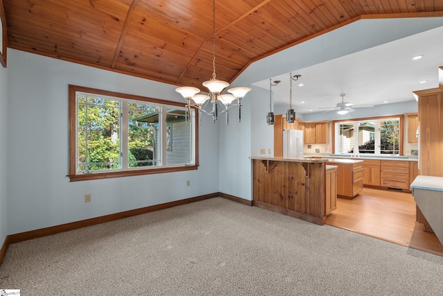 kitchen featuring white fridge, light colored carpet, and vaulted ceiling