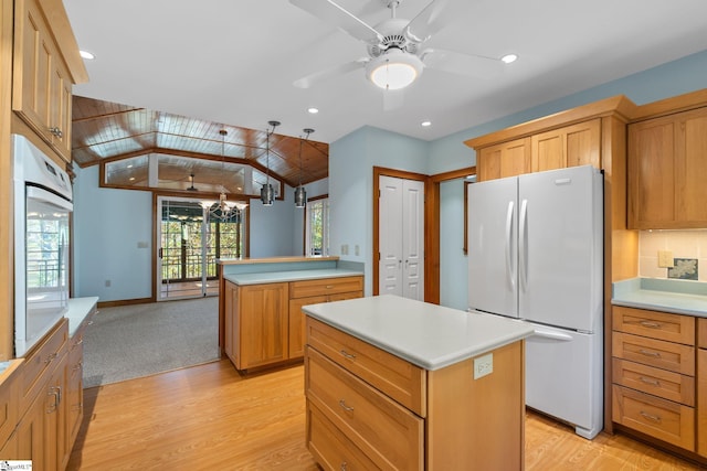 kitchen featuring a center island, white appliances, vaulted ceiling, light hardwood / wood-style floors, and kitchen peninsula