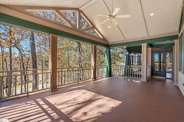 unfurnished sunroom with ceiling fan and lofted ceiling