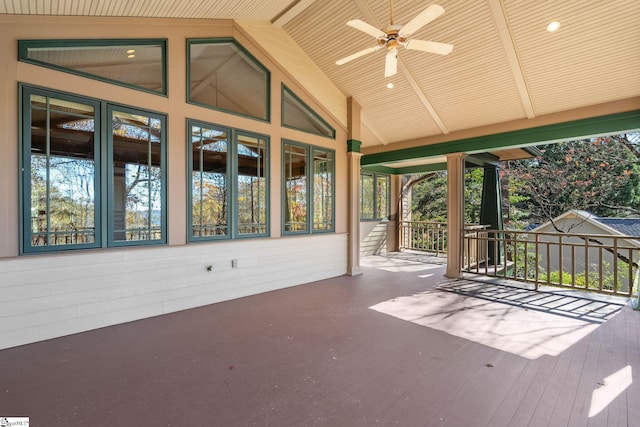 unfurnished sunroom featuring ceiling fan, wood ceiling, and lofted ceiling