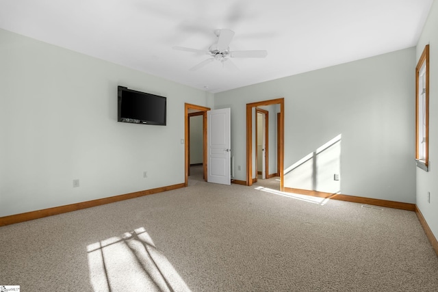 empty room with ceiling fan and light colored carpet