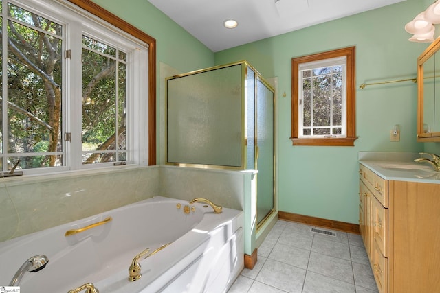 bathroom with tile patterned flooring, vanity, and separate shower and tub