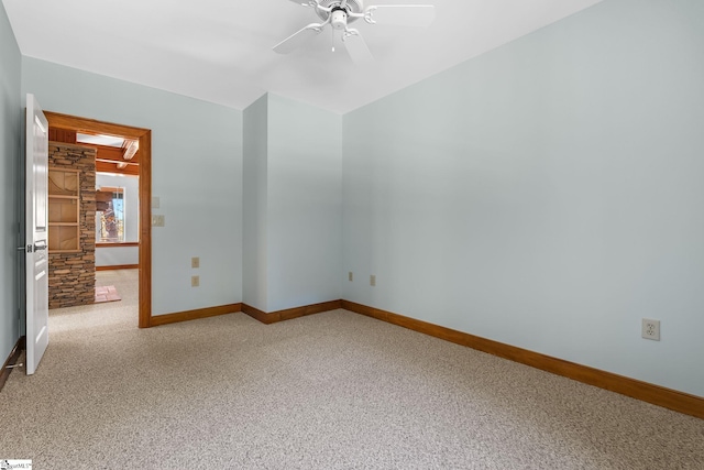 spare room with carpet floors and ceiling fan