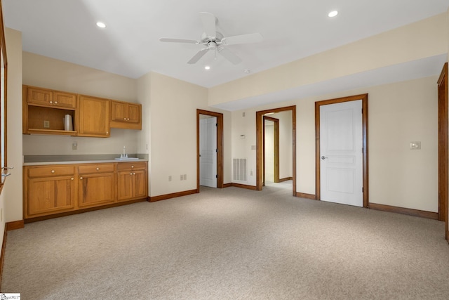 kitchen with light carpet, ceiling fan, and sink