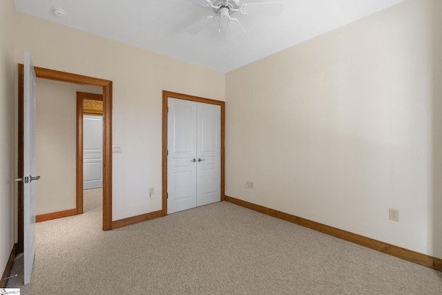 unfurnished bedroom featuring a closet, ceiling fan, and light colored carpet