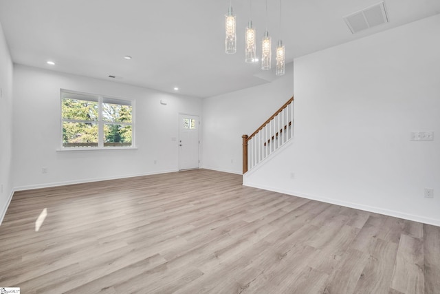 unfurnished living room with light hardwood / wood-style flooring