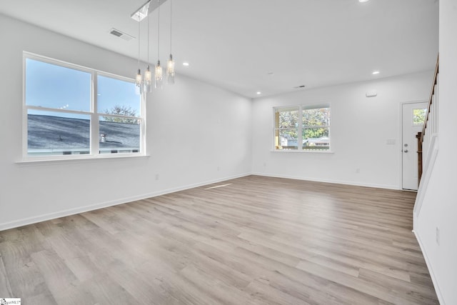 unfurnished room with light wood-type flooring