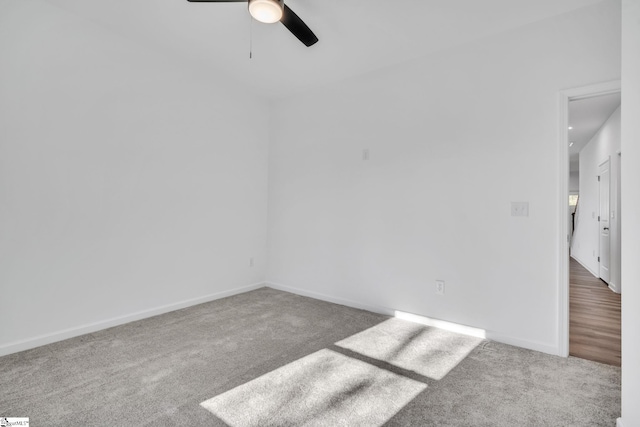 carpeted spare room with ceiling fan