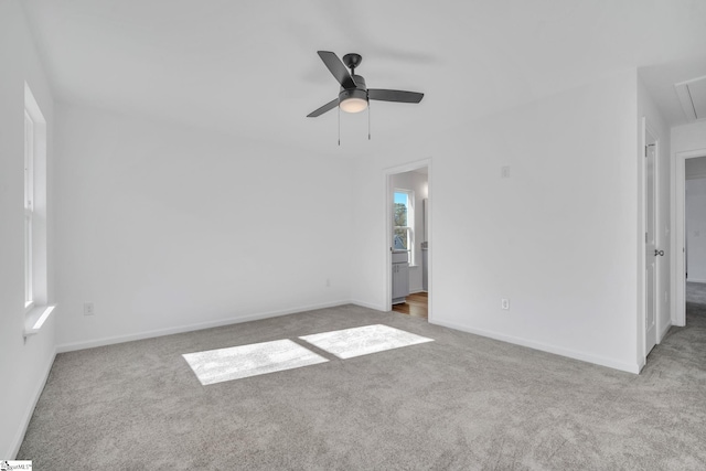 spare room with ceiling fan and light colored carpet