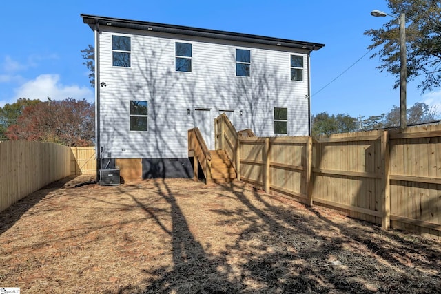 back of house featuring central AC