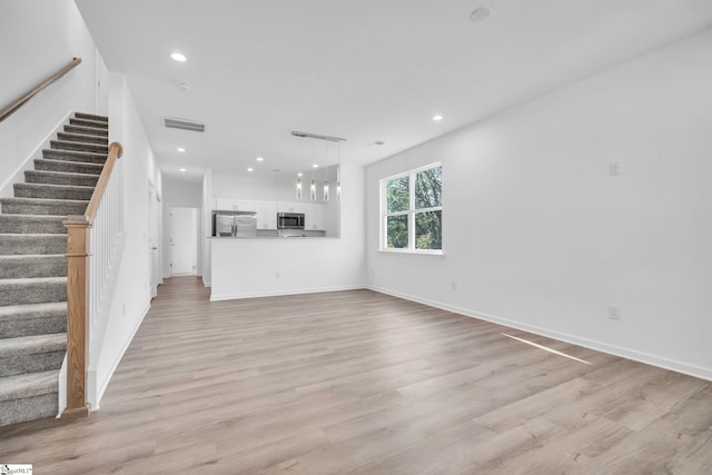 unfurnished living room featuring light wood-type flooring