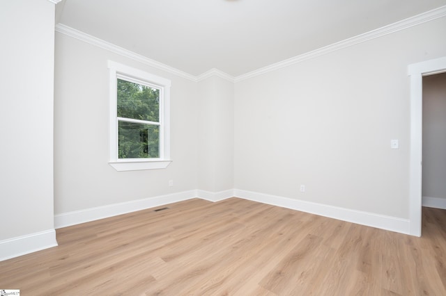 spare room with crown molding and light hardwood / wood-style flooring