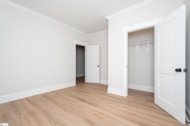 unfurnished bedroom featuring a closet, ornamental molding, and light hardwood / wood-style flooring