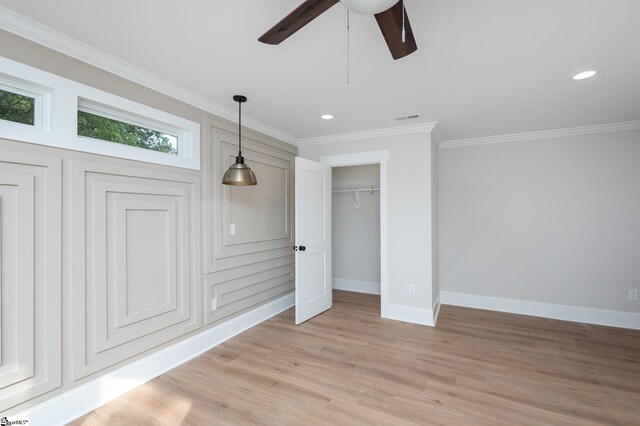 interior space featuring light hardwood / wood-style flooring, ceiling fan, and ornamental molding