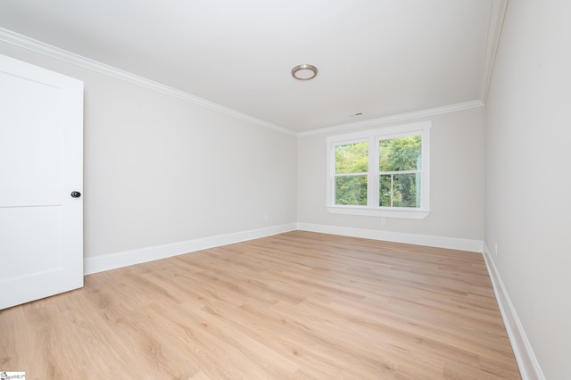 unfurnished room with crown molding and light hardwood / wood-style floors