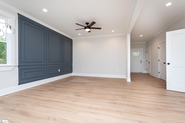 unfurnished room with light hardwood / wood-style floors, ceiling fan, and crown molding