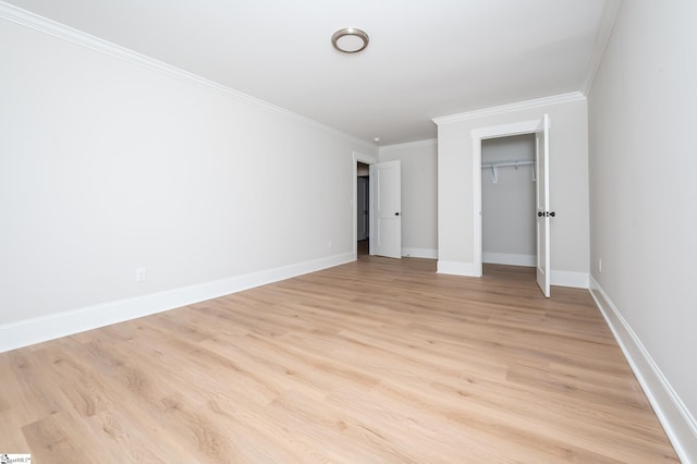 unfurnished bedroom with light wood-type flooring, a closet, and crown molding