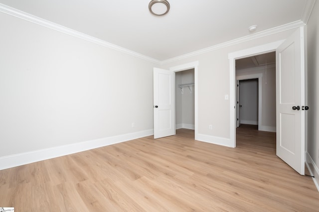 unfurnished bedroom featuring a closet, crown molding, and light hardwood / wood-style flooring