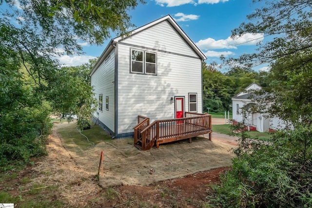 rear view of house with a wooden deck