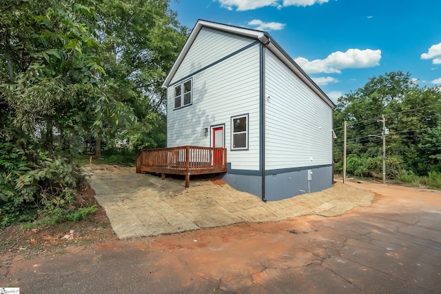 view of side of home featuring a deck