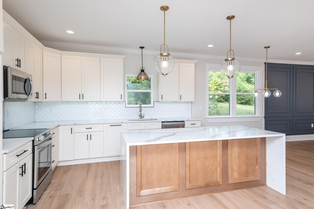 kitchen featuring a center island, white cabinetry, and stainless steel appliances