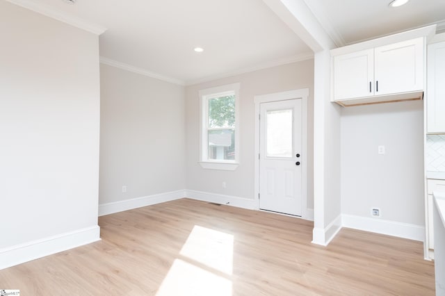 interior space featuring light hardwood / wood-style flooring and crown molding