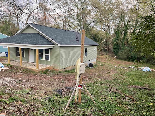 view of side of home featuring central air condition unit and covered porch