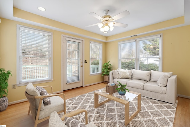 living room with light wood-type flooring, visible vents, a ceiling fan, recessed lighting, and baseboards