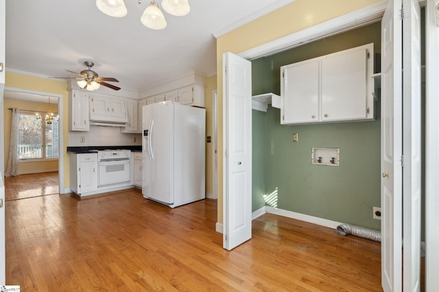 kitchen with white appliances, white cabinets, light wood finished floors, and ornamental molding