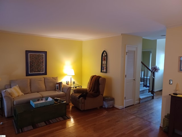 living room with baseboards, wood finished floors, stairs, and crown molding