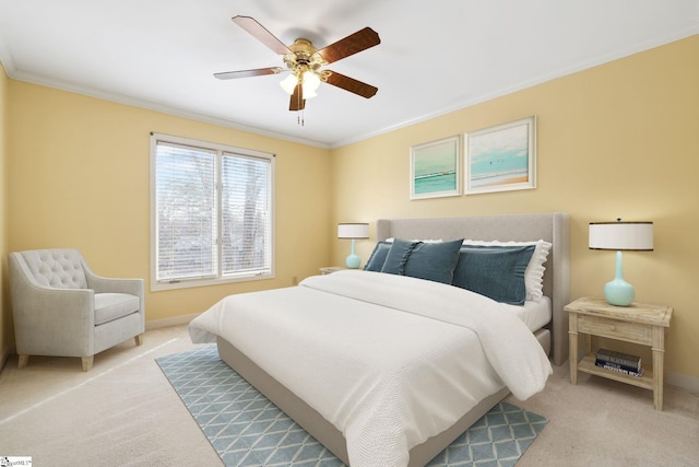 carpeted bedroom with crown molding, a ceiling fan, and baseboards