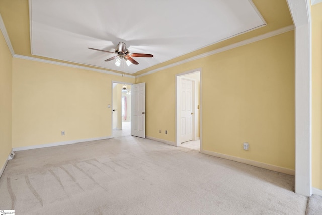 spare room featuring ceiling fan, baseboards, carpet floors, and ornamental molding