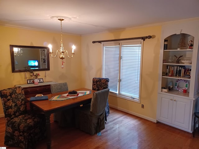 dining area featuring ornamental molding, baseboards, an inviting chandelier, and wood finished floors