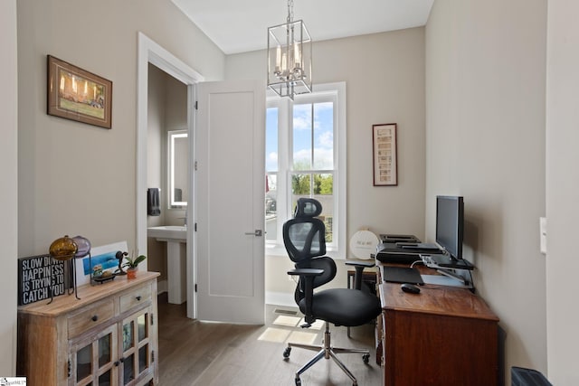 office space featuring wood-type flooring and a notable chandelier