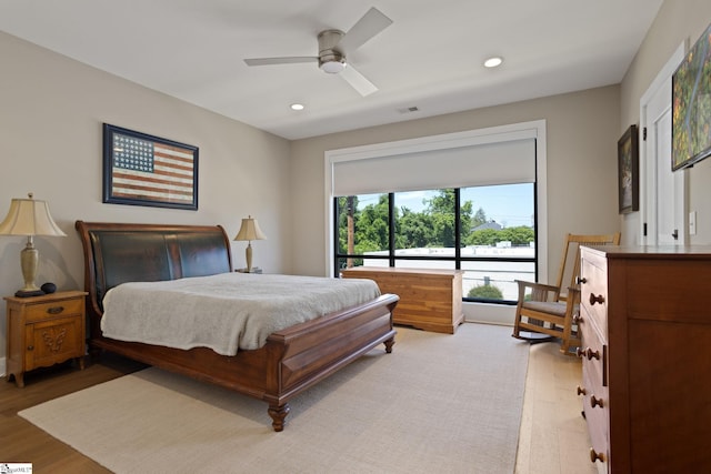 bedroom with ceiling fan and light hardwood / wood-style floors